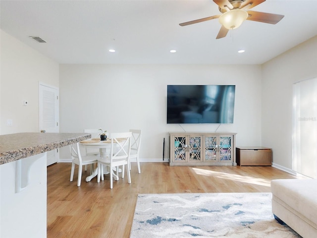 2775 Revolution St Unit 103, Melbourne, FL 32935 - living room with wood finished floors, visible vents, a ceiling fan, and baseboards