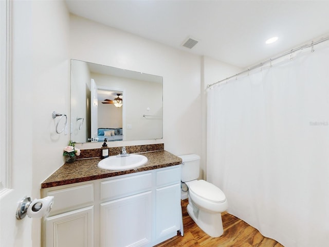 2775 Revolution St Unit 103, Melbourne, FL 32935 - ensuite bathroom featuring wood finished floors, connected bathroom, vanity, toilet, and visible vents