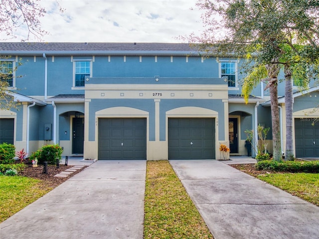 2775 Revolution St Unit 103, Melbourne, FL 32935 - view of front of house featuring concrete driveway and stucco siding