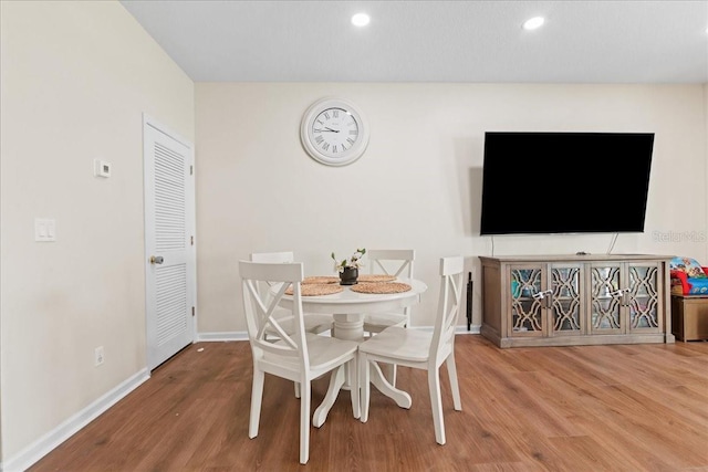 2775 Revolution St Unit 103, Melbourne, FL 32935 - dining area featuring baseboards, recessed lighting, and wood finished floors