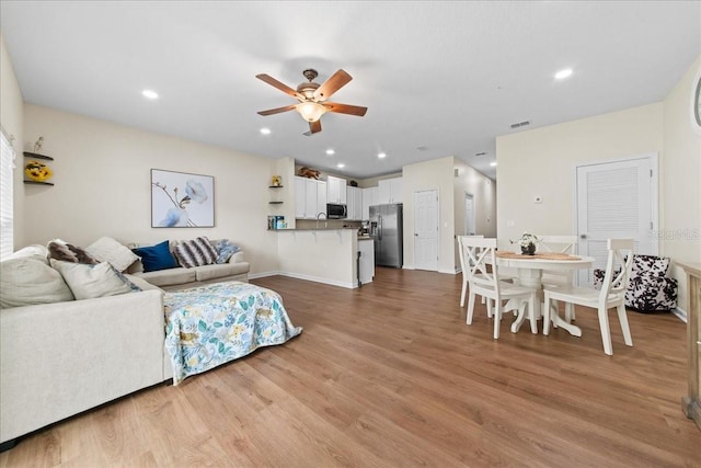 2775 Revolution St Unit 103, Melbourne, FL 32935 - living area featuring recessed lighting, ceiling fan, wood finished floors, and baseboards