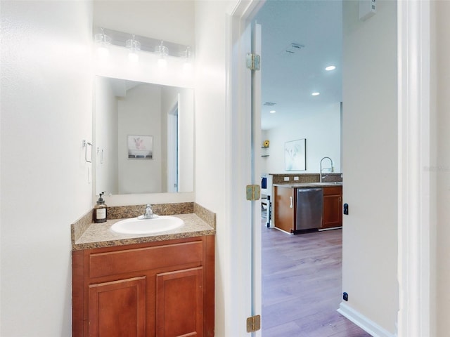 2775 Revolution St Unit 103, Melbourne, FL 32935 - bathroom with wood finished floors, vanity, and recessed lighting