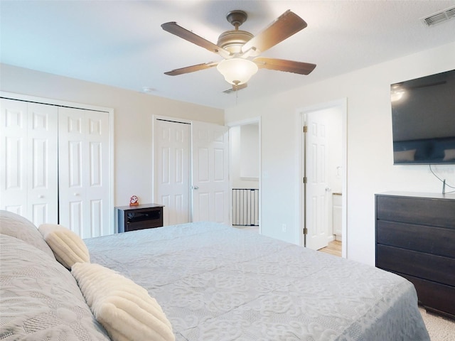 2775 Revolution St Unit 103, Melbourne, FL 32935 - bedroom featuring ensuite bath, a ceiling fan, visible vents, and two closets