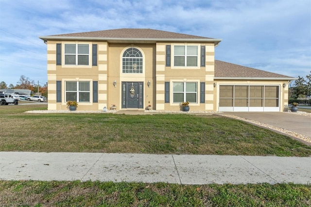 view of front facade featuring a garage and a front lawn