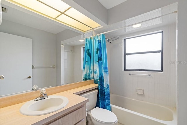 full bathroom featuring toilet, vanity, and shower / tub combo with curtain