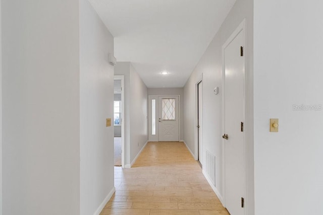 corridor with light wood-type flooring