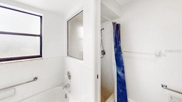 bathroom with shower / bath combo with shower curtain