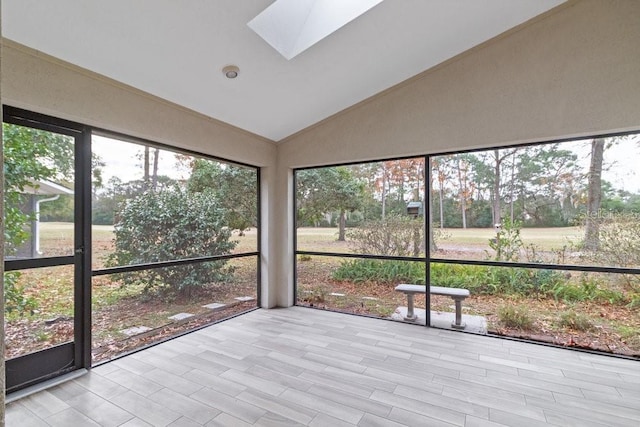 unfurnished sunroom with vaulted ceiling with skylight