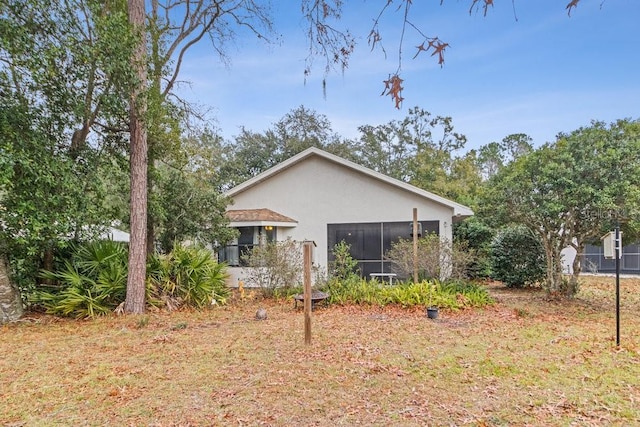 back of property featuring a sunroom