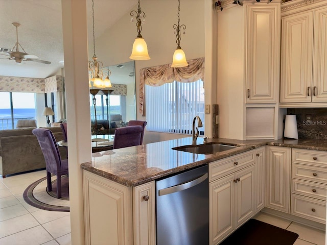 kitchen with tasteful backsplash, dishwasher, sink, decorative light fixtures, and plenty of natural light