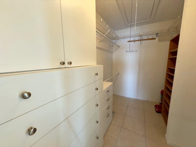 spacious closet featuring light tile patterned floors