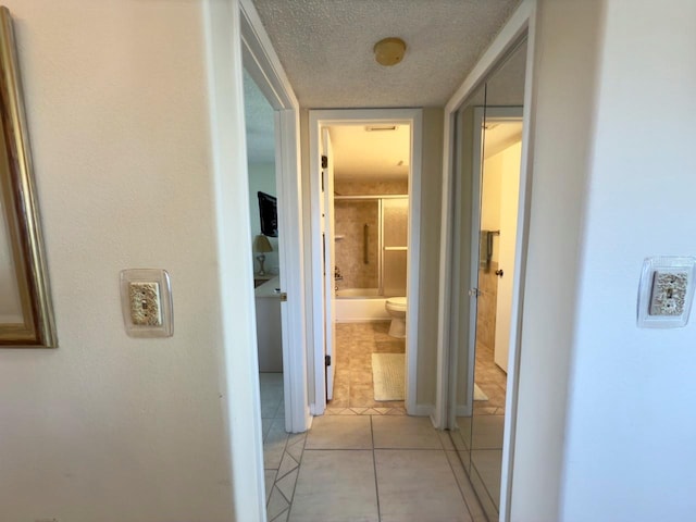 hall with light tile patterned flooring