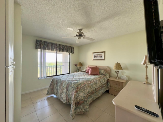 bedroom featuring ceiling fan, a textured ceiling, and light tile patterned floors