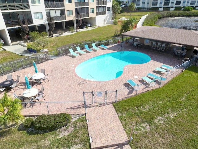 view of pool featuring a lawn and a patio