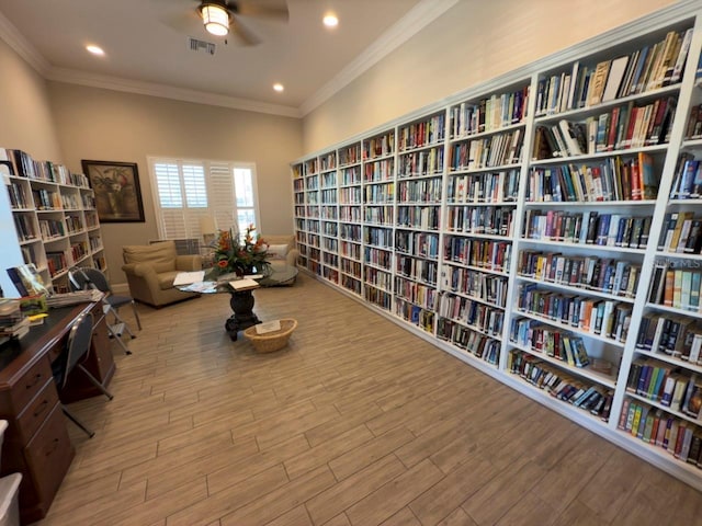 sitting room featuring ceiling fan, hardwood / wood-style floors, and crown molding