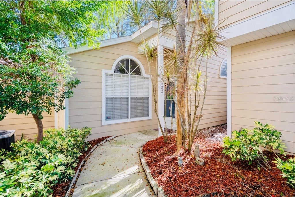 doorway to property featuring central AC unit