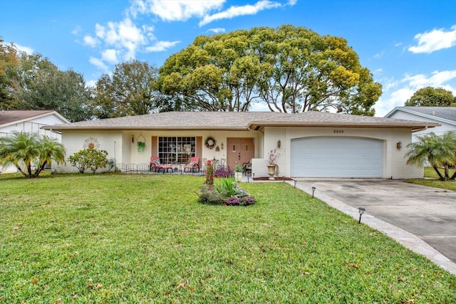 ranch-style home featuring a garage and a front lawn