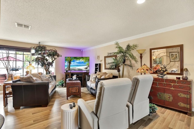 living room featuring light hardwood / wood-style floors, a textured ceiling, and crown molding