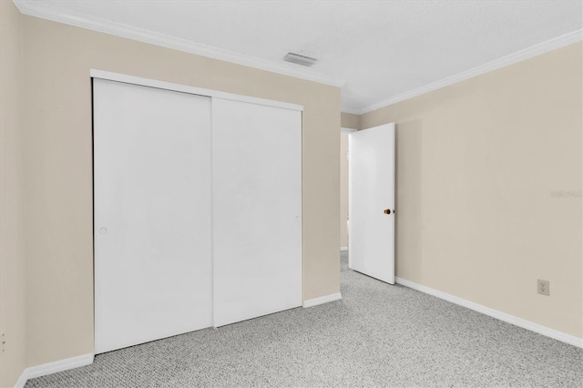 unfurnished bedroom featuring light carpet, a closet, and ornamental molding