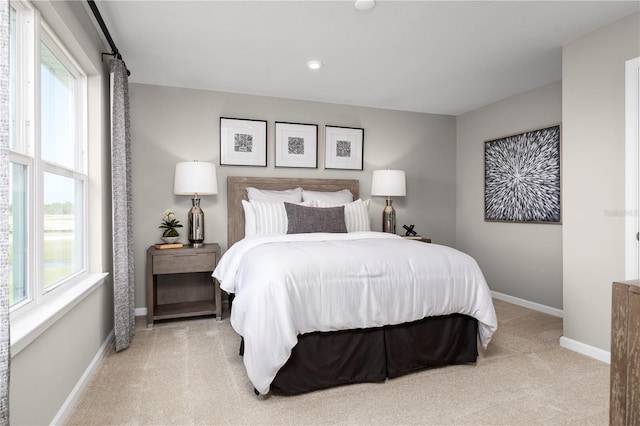 carpeted bedroom featuring multiple windows