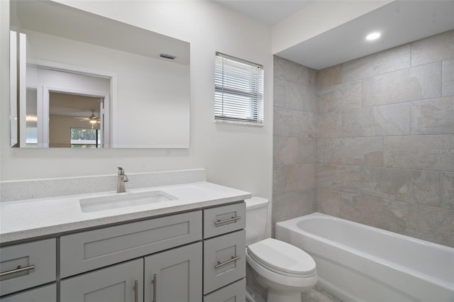 full bathroom with toilet, vanity, and tiled shower / bath combo