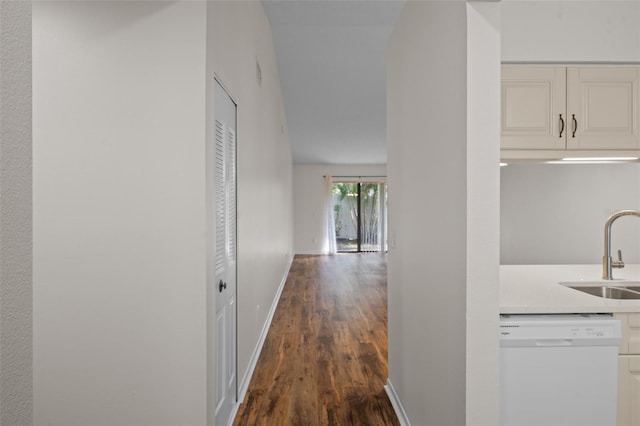 corridor featuring sink and dark hardwood / wood-style floors