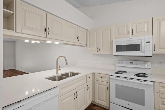 kitchen featuring dark wood-type flooring, sink, and white appliances