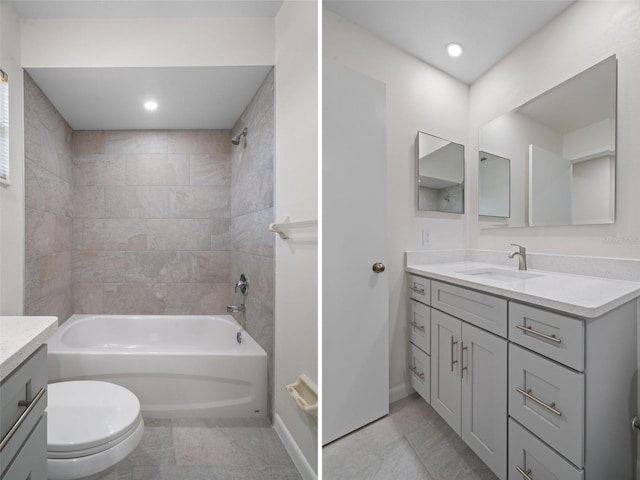 full bathroom featuring tiled shower / bath combo, vanity, and toilet