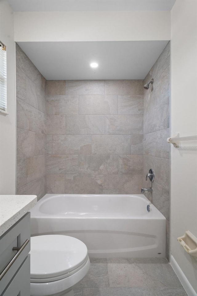 full bathroom with toilet, vanity, tile patterned floors, and tiled shower / bath