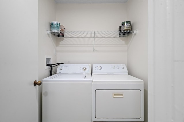 clothes washing area featuring washing machine and clothes dryer