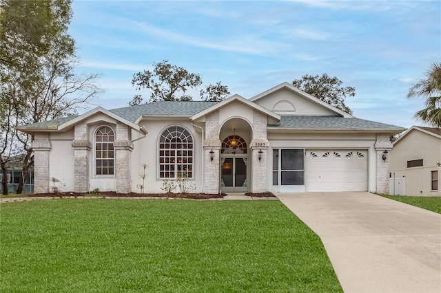 ranch-style house with a garage and a front lawn