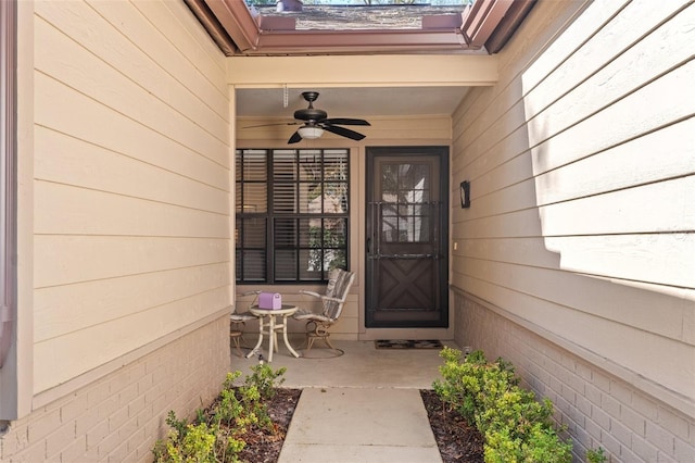 view of exterior entry with ceiling fan