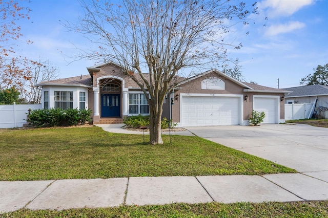 ranch-style home with a garage and a front lawn