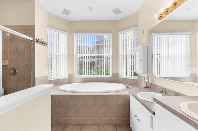 bathroom with vanity, shower with separate bathtub, and tile patterned floors