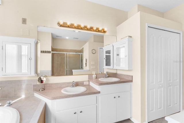 bathroom featuring vanity and shower with separate bathtub