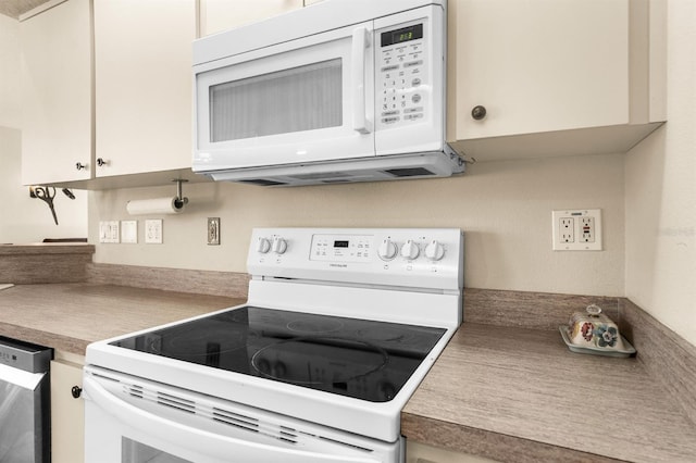 kitchen with white appliances and white cabinets