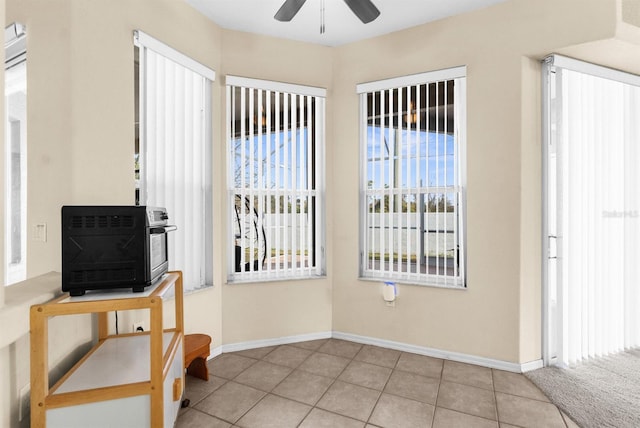 entryway with light tile patterned floors and ceiling fan