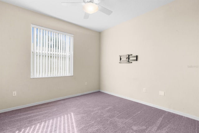 spare room featuring carpet flooring and ceiling fan