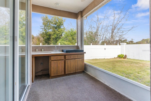 unfurnished sunroom with sink