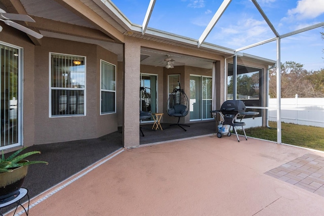 unfurnished sunroom featuring ceiling fan