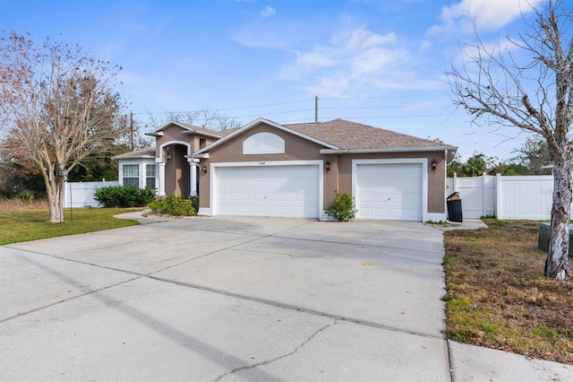 single story home featuring a garage and a front yard