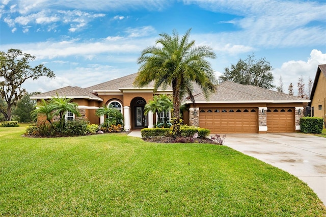 view of front of house with a garage and a front lawn