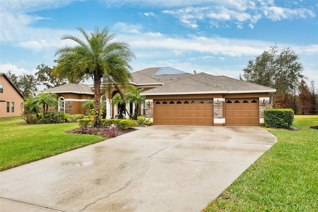 view of front of house featuring a garage and a front lawn