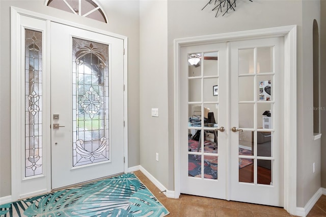 tiled foyer entrance featuring french doors