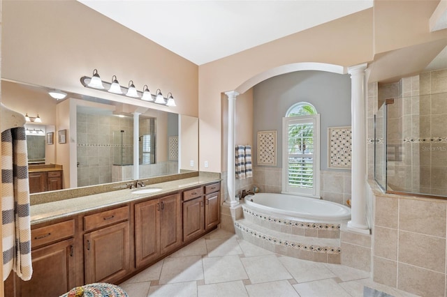 bathroom featuring vanity, tile patterned flooring, shower with separate bathtub, and ornate columns