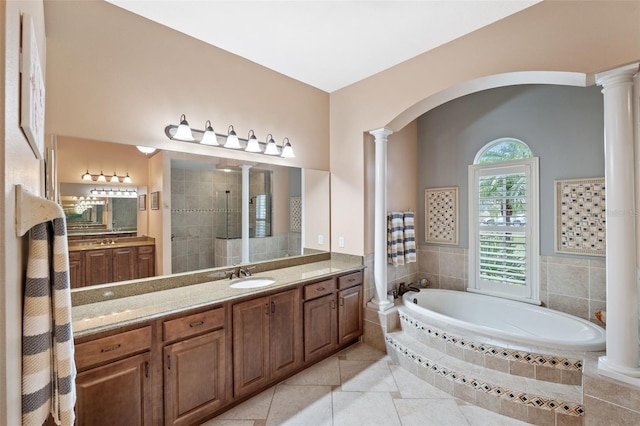 bathroom featuring decorative columns, tile patterned floors, vanity, and shower with separate bathtub