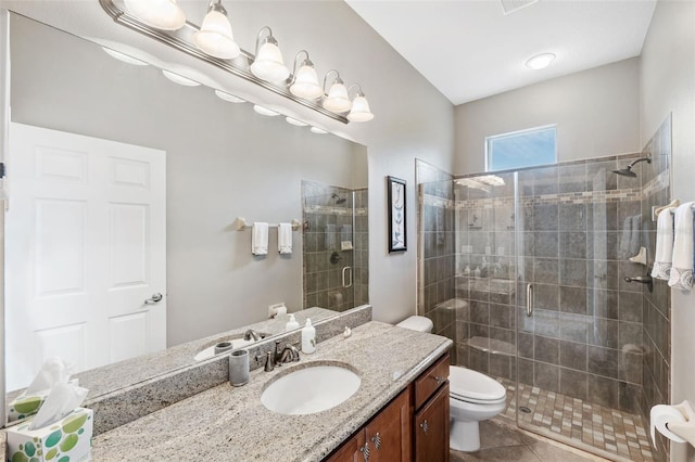 bathroom featuring toilet, tile patterned flooring, an enclosed shower, and vanity