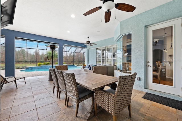 view of patio / terrace featuring glass enclosure and ceiling fan