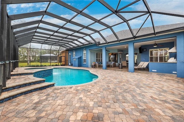 view of pool featuring an in ground hot tub, a lanai, a patio, ceiling fan, and an outdoor hangout area