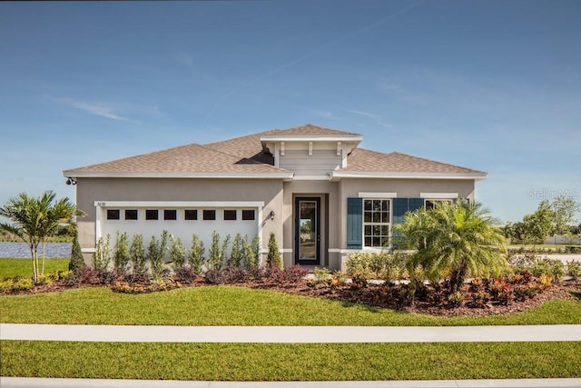 view of front of home featuring a front lawn and a garage